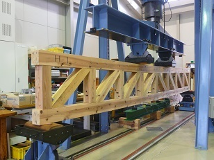 写真：中山間地域研究センターで長さ６ｍのトラス梁を製造して曲げ試験を行いました。