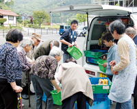 コンビニエンスストアの移動販売車と連携した買い物支援をする様子